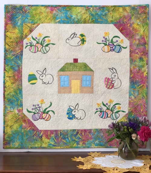Finished quilt with Easter eggs and Easter bunnies embroidery.