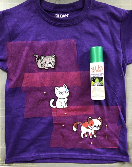 Stitch-outs of the kittens placed on a t-shirt