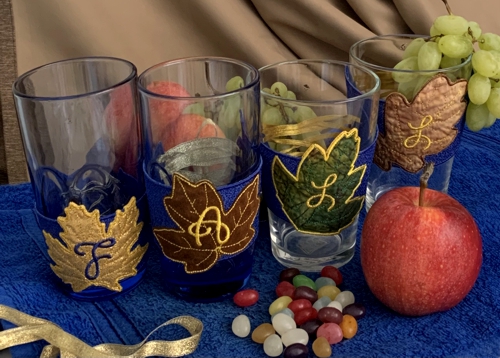 Four glasses with embroidered belts.