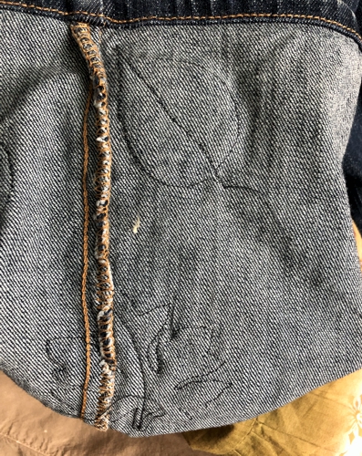 The wromg side of the jeans with attached leaf.