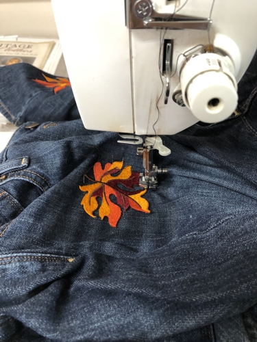 A leaf stitch-out sewn to the jeans