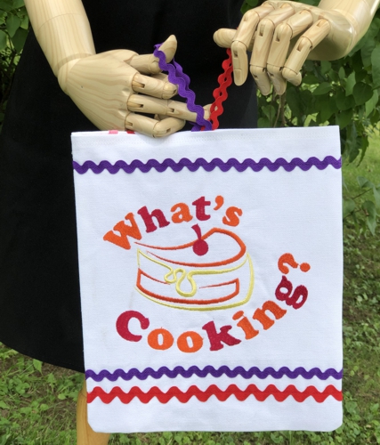 Kitchen sign with "what's cooking" embroidery