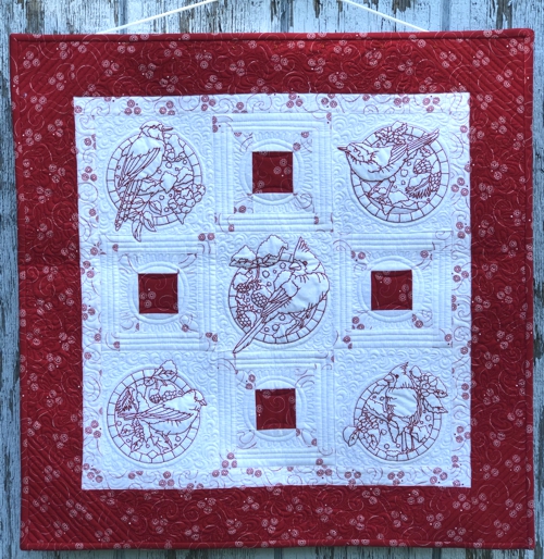 Finished quilt with bird embroidery