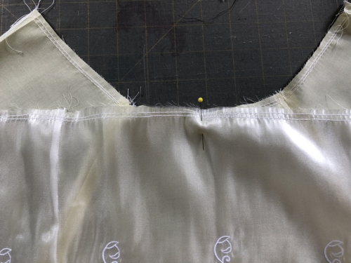 Match the center of the overlay with the center of the skirt's front.
