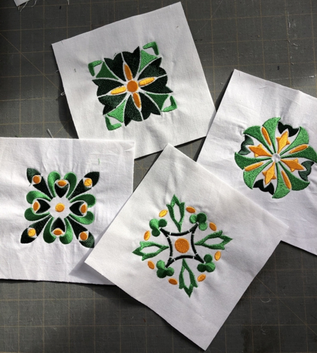 Stitch-outs of 4 designs from the Shamrock tile set.