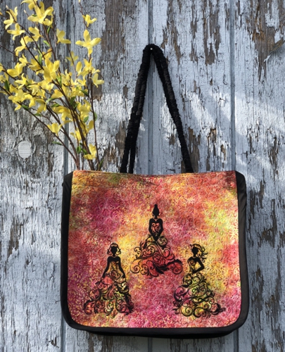 Quilted tote bag with the embroidery of 3 ladies in spring gowns.