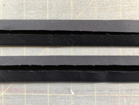 Black strips with folded long edges.