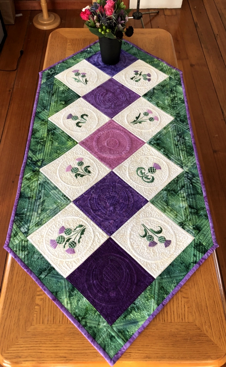 Finished tablerunner with thistle embroidery.