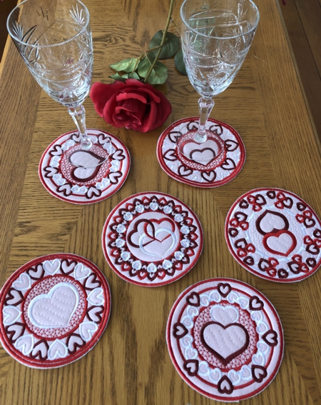 FInished coasters on the table with glasses and flowers