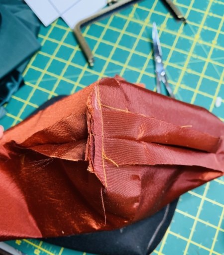 The lining of the purse with the boxed corners and opening in the bottom.