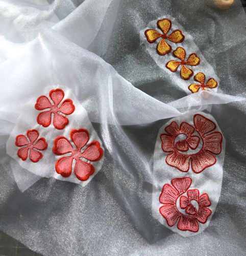 Stitch-outs of the flowers on organza.
