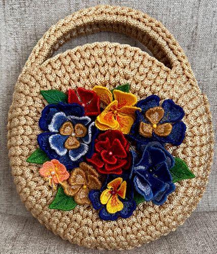 A crochet bag decorated with the 3D embroidered flowers