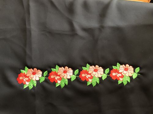 2-flower design embroidered on the front and back panels of the skirt.