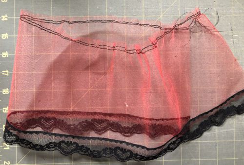 Stitch the lace to the lower edge of the tulle.