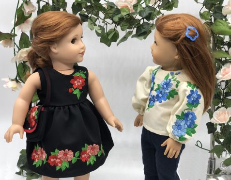 Two dolls in embroidered dress and blouse.