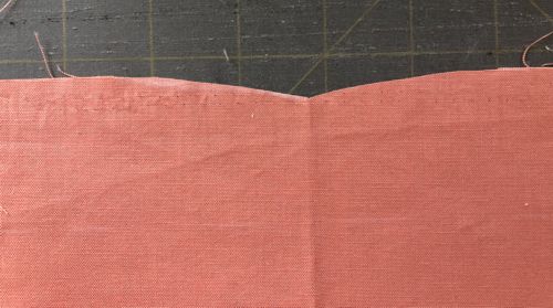 Photo showing how to cut a curve in the center of the skirt on the top edge.