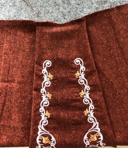 Photo showing the gathering stitches along the upper edge of the skirt.