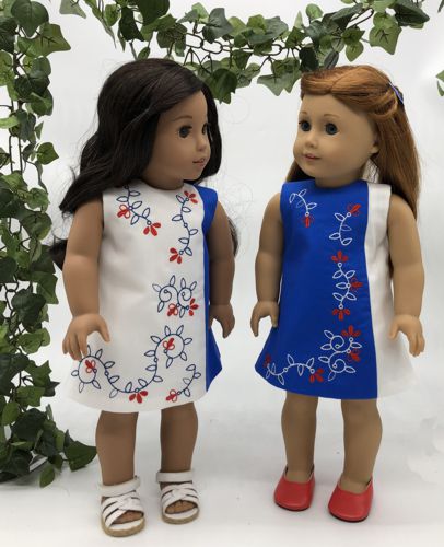 2 dolls in finished dresses with embroidery