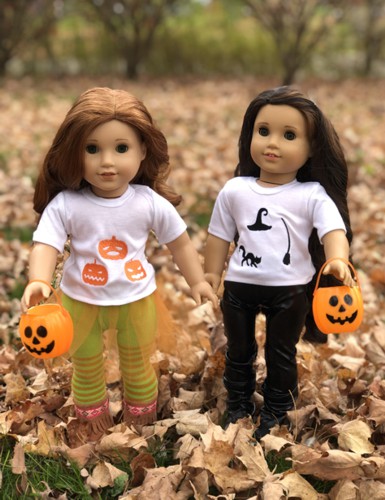 Dolls in t-shirts decorated with Halloween-themed embroidery