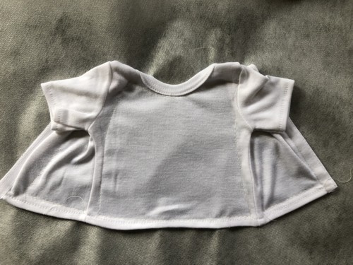 The doll t-shirt basted to the stabilizer.