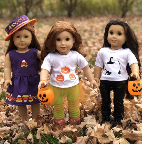 3 dolls in Halloween costumes decorated with embroidery.