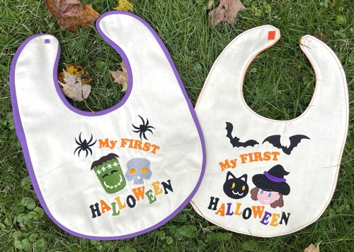 2 baby bibs with Halloween-themed embroidery