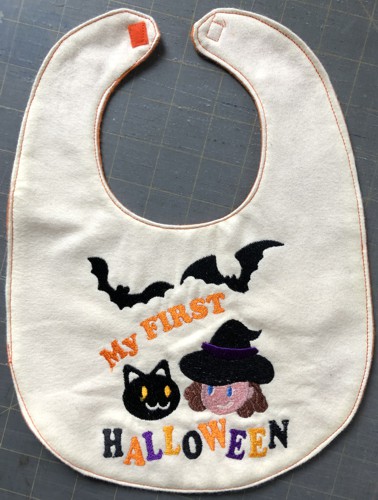 The finished bib with topstitched edges and Velcro tape attached.