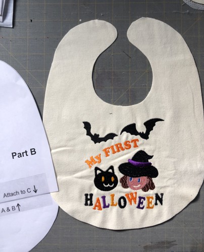 The front of the bib with embroidery is cut out.