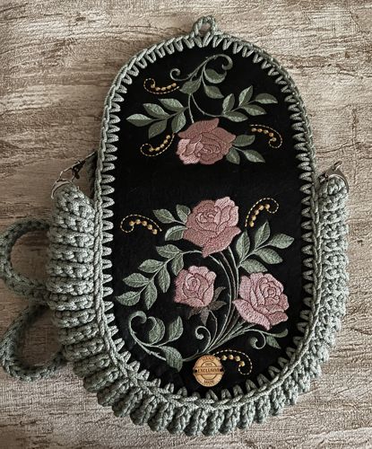 Oreo bag with camellia embroidery open so that the embroidery on the back panel and the flap is seen.