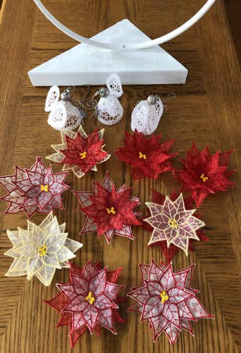 Stitch-outs of poinsettias and angels.