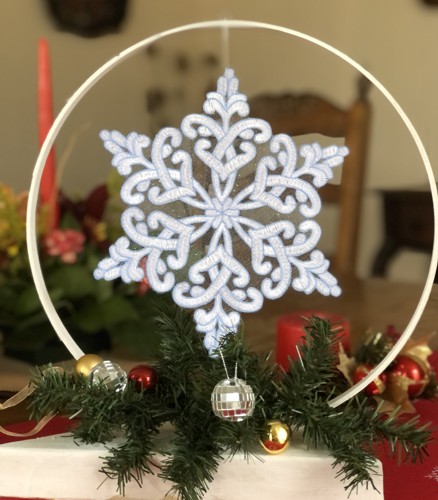 A Stitch-out of a snowflake in a hoop.
