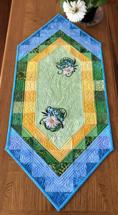 Green and blue tablerunner with daisy embroidery