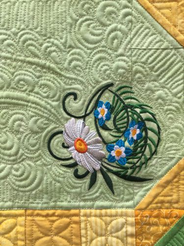 Close-up of the quilting pattern and embroidery.