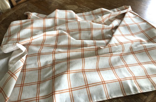 Light cream-and-orange tablecloth.
