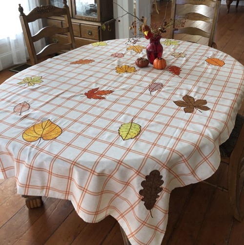 The finished tablecloth with applique embroidery.