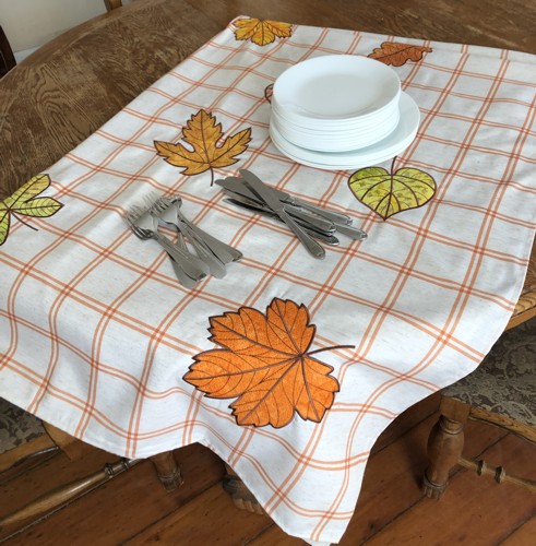 Finished tablecloth with plates and silverware.