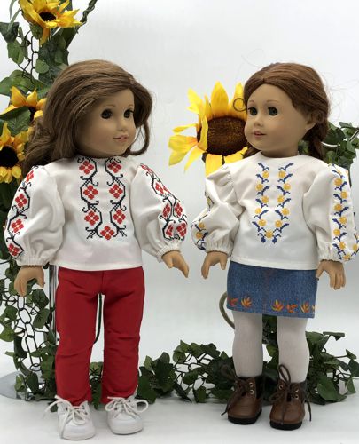 2 dolls in finished blouses with embroidery.