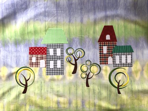 Applique houses are attached to the background.