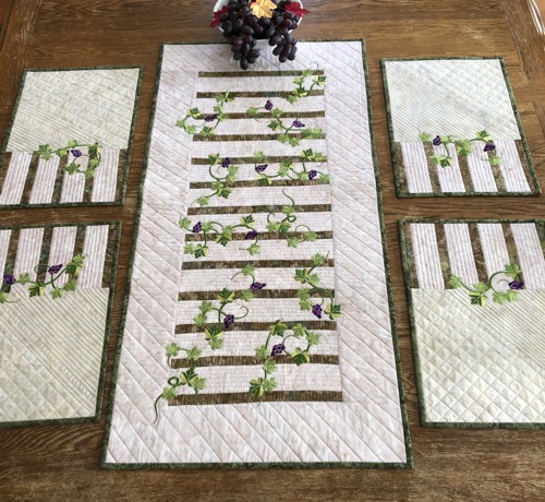 Finished quilted tablerunner and 4 placemats with grape vines embroidery