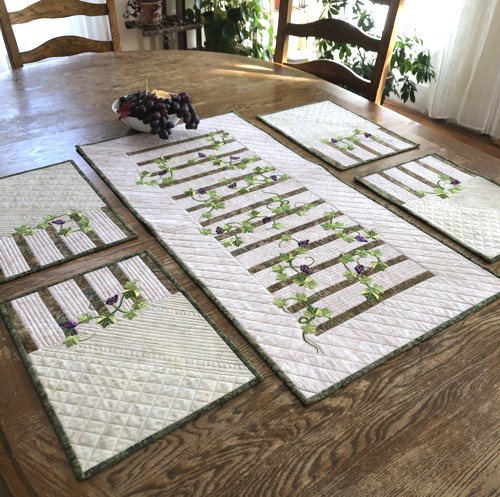 Finished quilted tablerunner and 4 placemats with grape vines embroidery