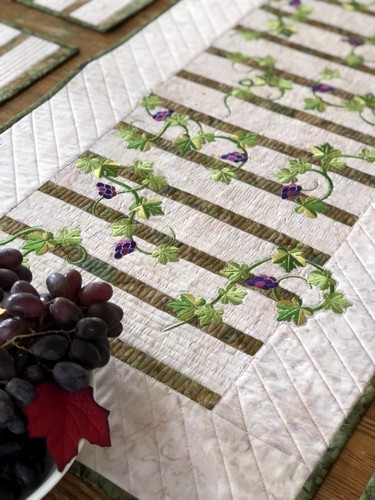 Close-up of the finished runner with grape vines embroidery.