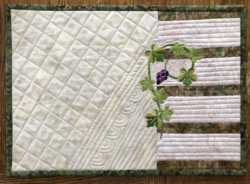 Close-up of the quilting and embroidery on a placemat.