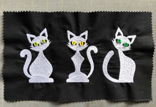 Sew the buttons onto the cats.