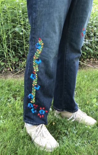 Jeans embroidered with the designs from Morning Glory Set. Close-up of the embroidery.