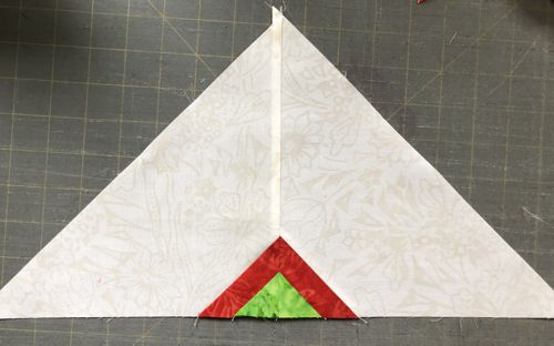 Two triangles stitched together in a new one.