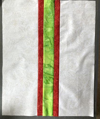 The central part of the top with green, red and cream strips sewn together