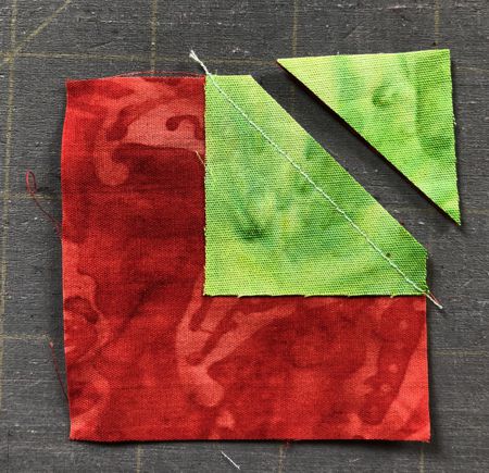 Stitch the green square on diagonal. Cut away the corner with seam allowance 1/4".