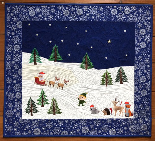 Finished wall quilt with Santa in a sleigh, tree and animal embroidery