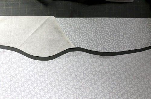 Fabric is cut along the curved line.