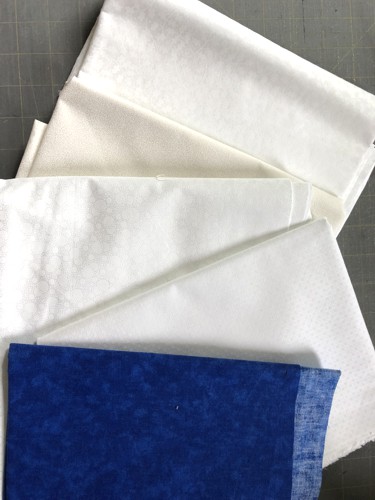 A selection of white , ivory and blue fabrics